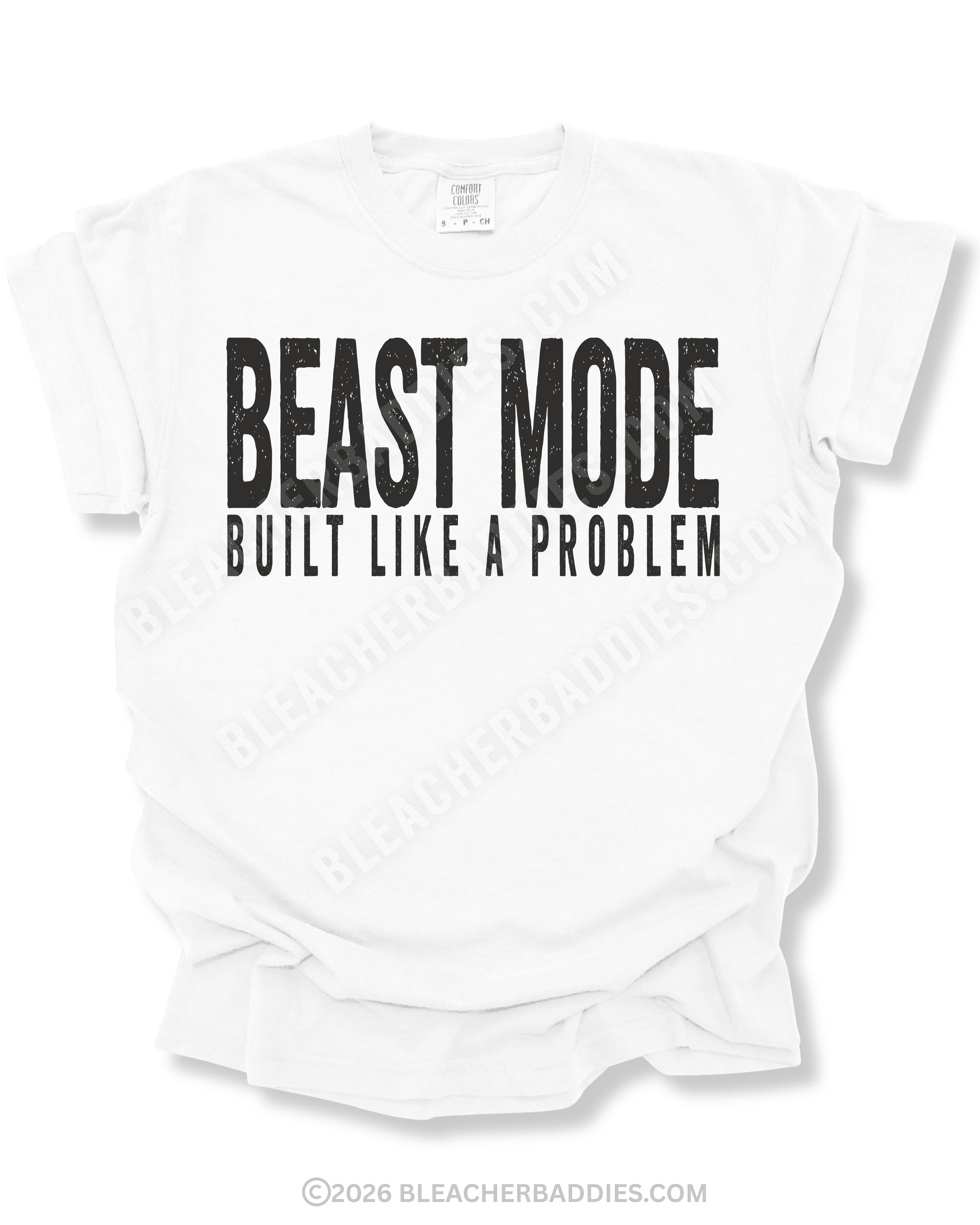 White Comfort Colors football game day shirt with distressed black “BEAST MODE BUILT LIKE A PROBLEM” graphic displayed on a flat lay mockup against a light background.
