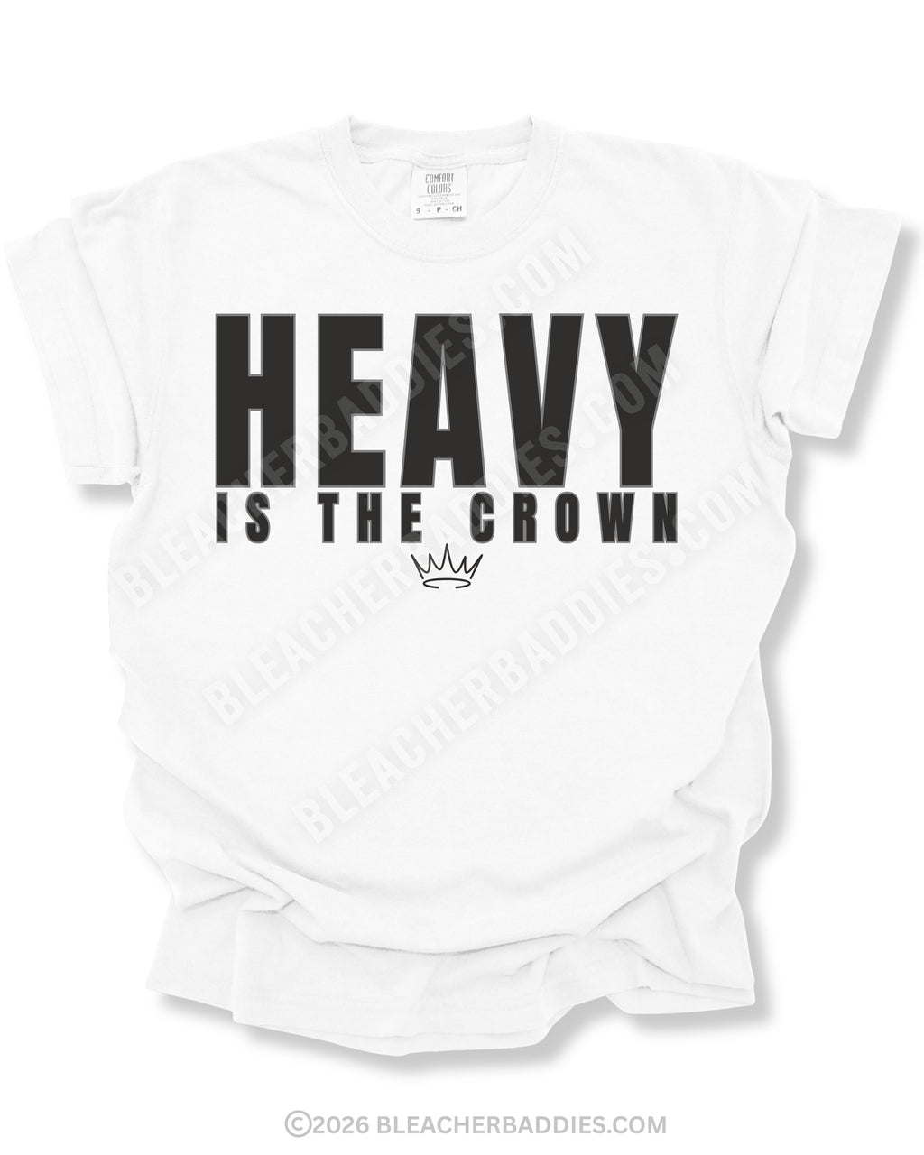 White graphic t-shirt featuring bold black “HEAVY IS THE CROWN” text with a minimalist crown graphic underneath displayed on a relaxed fit short sleeve shirt against a white background.