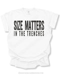 White Comfort Colors football game day shirt flat lay featuring distressed black “Size Matters In The Trenches” typography designed for offensive and defensive linemen.