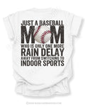 White Comfort Colors game day shirt with distressed back graphic reading “Just a Baseball Mom Who Is Only One More Rain Delay Away From Switching To Indoor Sports” with baseball graphic layered over MOM text