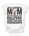 White game day shirt with oversized distressed back graphic reading “Just a Baseball Mom Who Has Been at This Ballpark Longer Than Some Friendships” with baseball graphic layered over MOM text