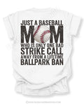 White Comfort Colors game day shirt with distressed back graphic reading “Just a Baseball Mom Who Is Only One Bad Strike Call Away From A Lifetime Ballpark Ban” with baseball graphic layered over MOM text