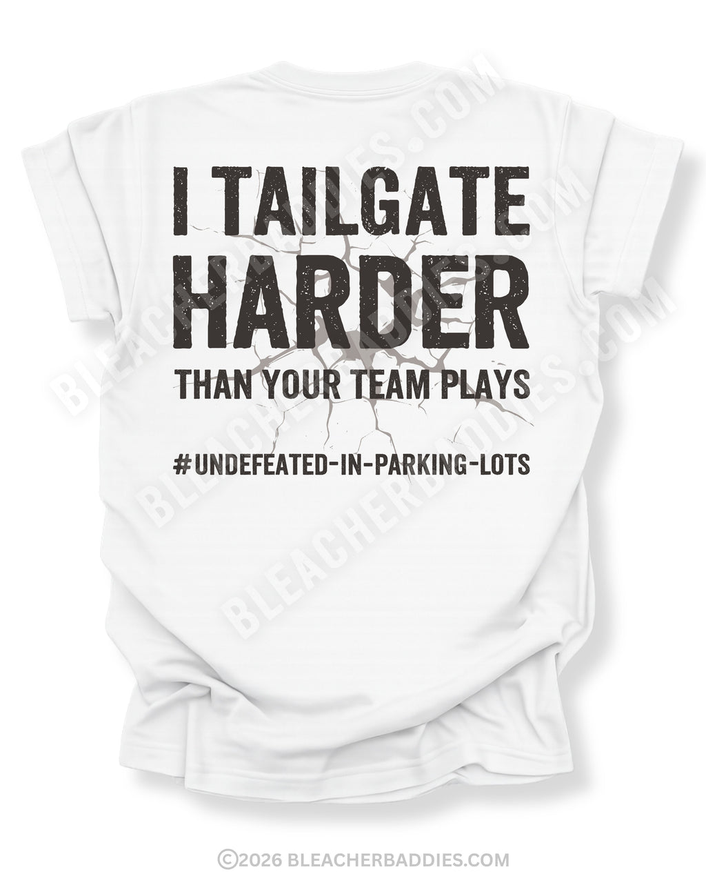 White Comfort Colors football mom game day shirt flat lay with back design that reads “I tailgate harder than your team plays #undefeated-in-parking-lots” in distressed black text with cracked graphic