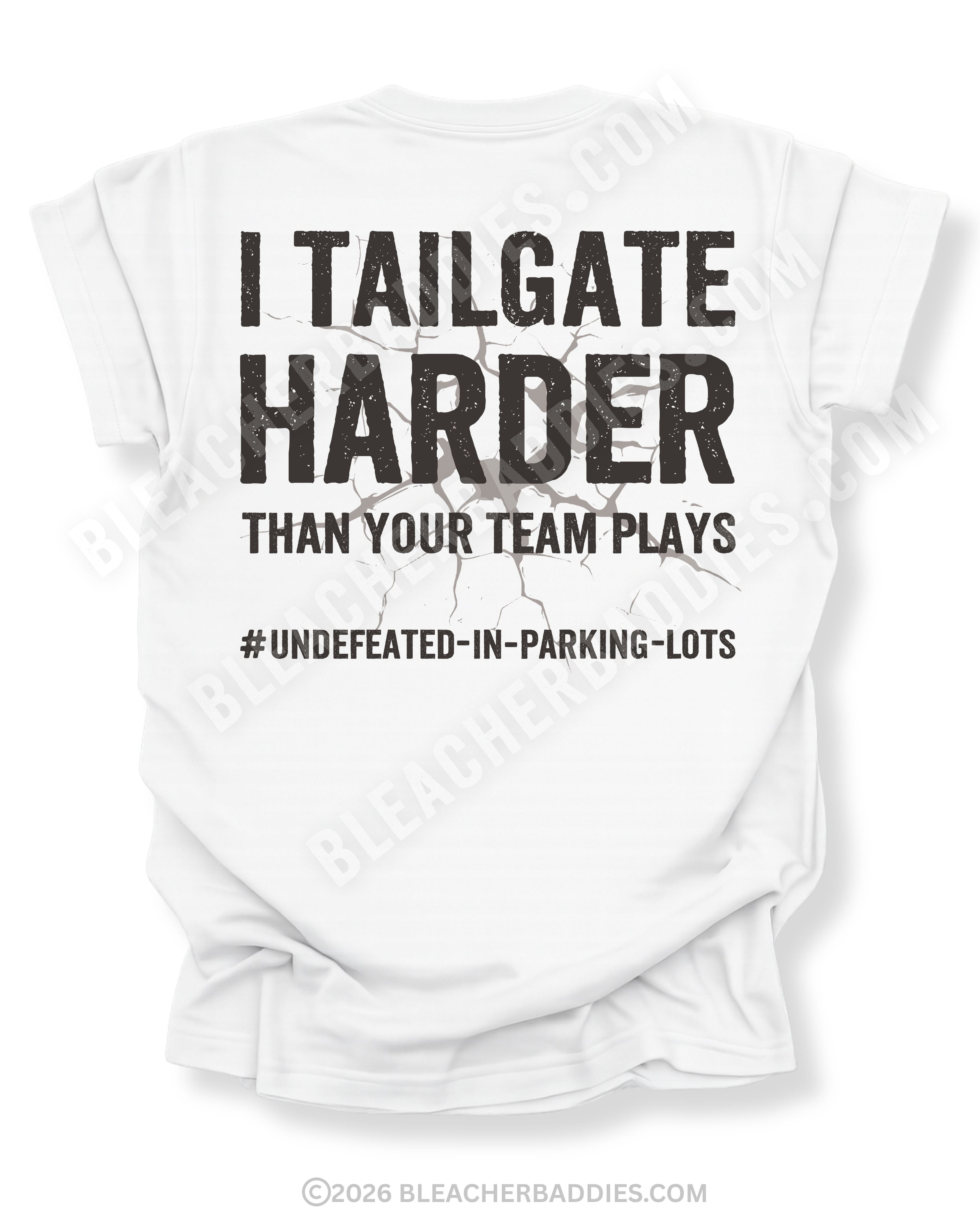White Comfort Colors football mom game day shirt flat lay with back design that reads “I tailgate harder than your team plays #undefeated-in-parking-lots” in distressed black text with cracked graphic