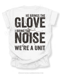 White Comfort Colors baseball mom graphic tee with distressed oversized back design reading “He Brings The Glove I Bring The Noise We’re A Unit” featuring vintage cracked effect and BleacherBaddies.com watermark across design.