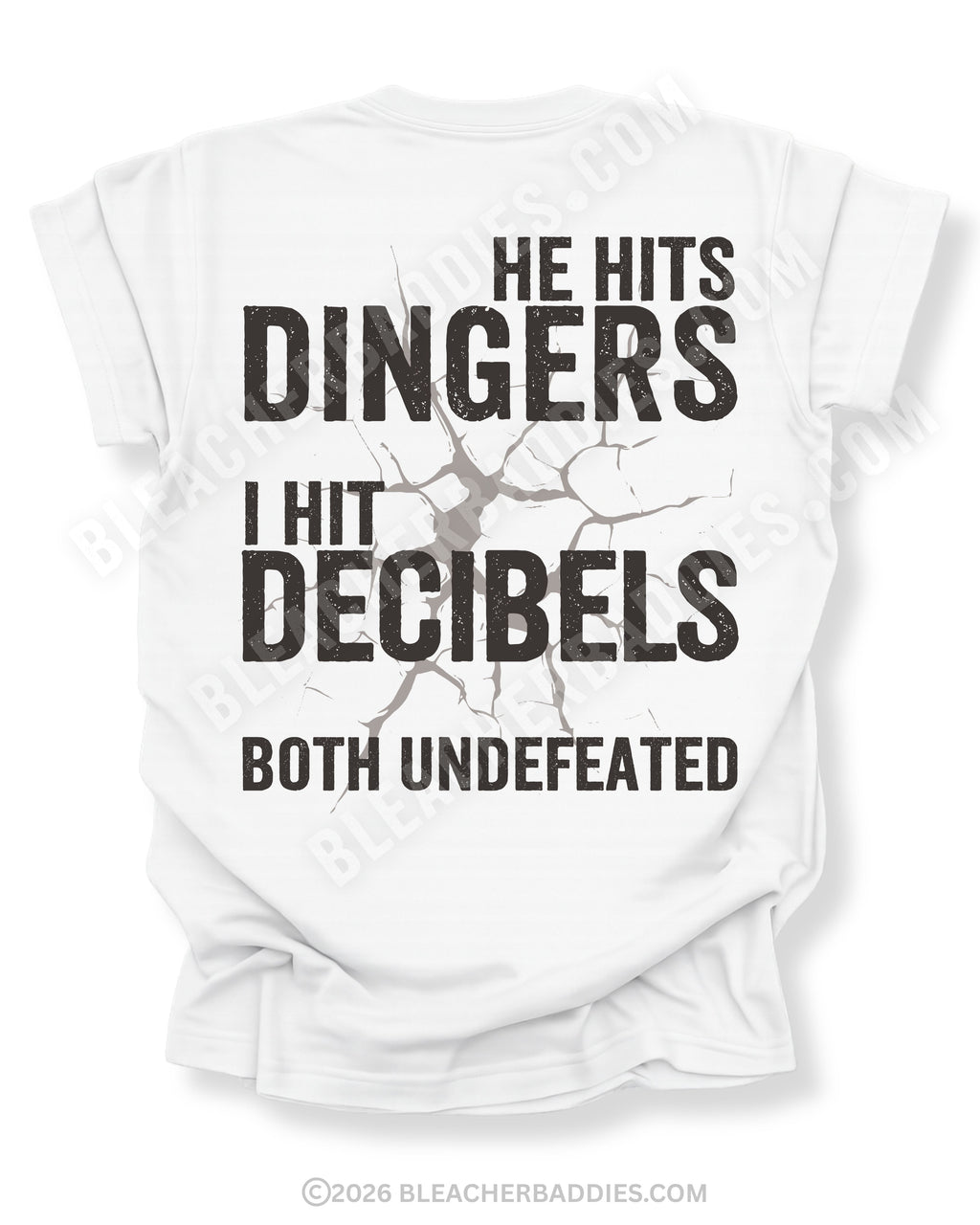 White Comfort Colors baseball mom game day shirt with distressed oversized typography reading “He Hits Dingers I Hit Decibels Both Undefeated” across the back