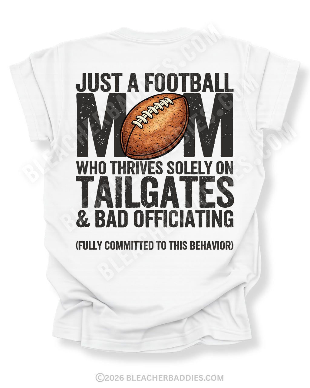 Football mom game day shirt on a white Comfort Colors tee, featuring a back graphic that says, “Just a football mom who thrives solely on tailgates & bad officiating (fully committed to this behavior).”