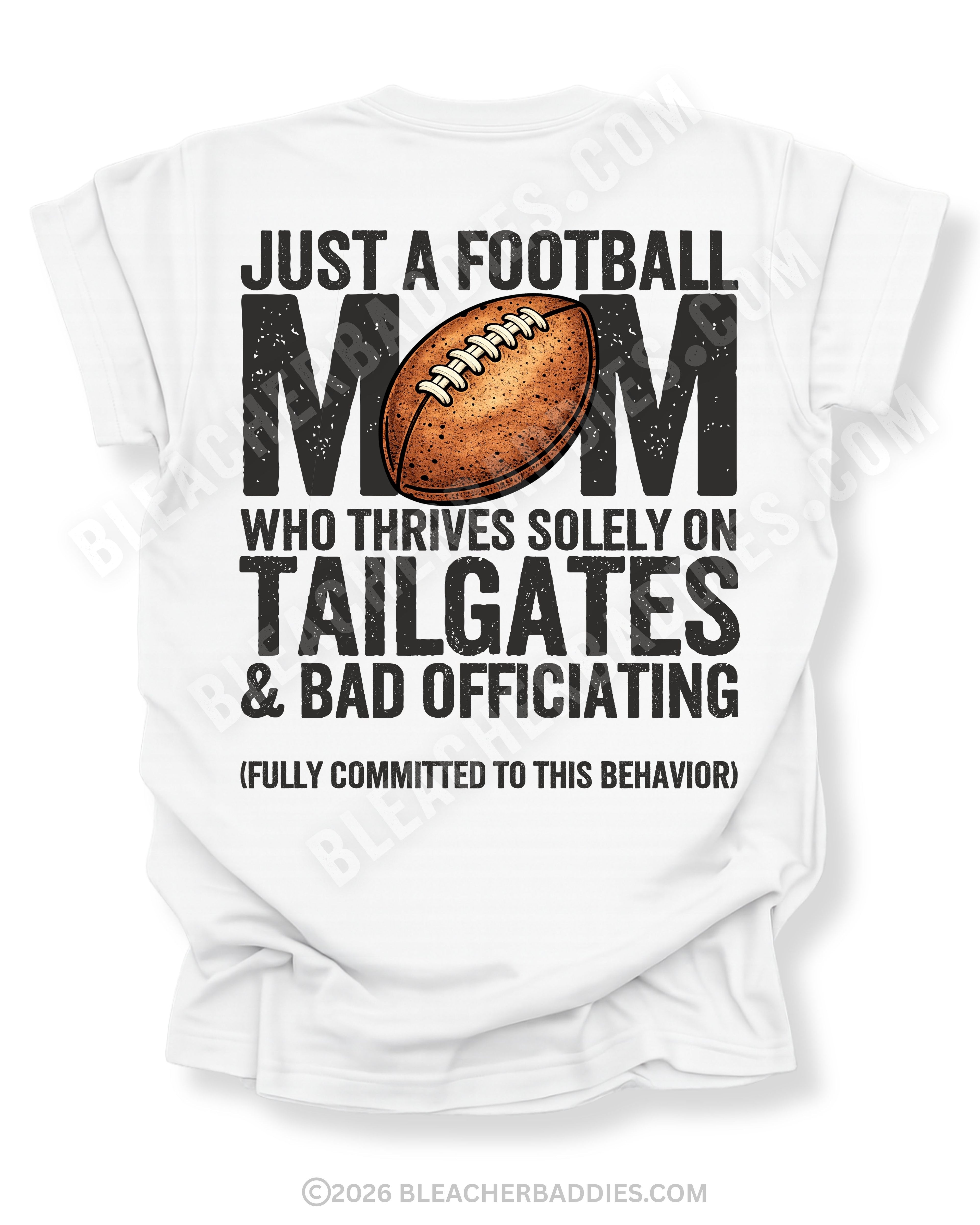 Football mom game day shirt on a white Comfort Colors tee, featuring a back graphic that says, “Just a football mom who thrives solely on tailgates & bad officiating (fully committed to this behavior).”