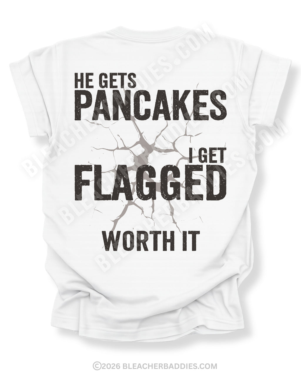 Football mom game day shirt with back design that reads “He gets pancakes I get flagged worth it” in distressed black text with a cracked impact graphic on a white tee