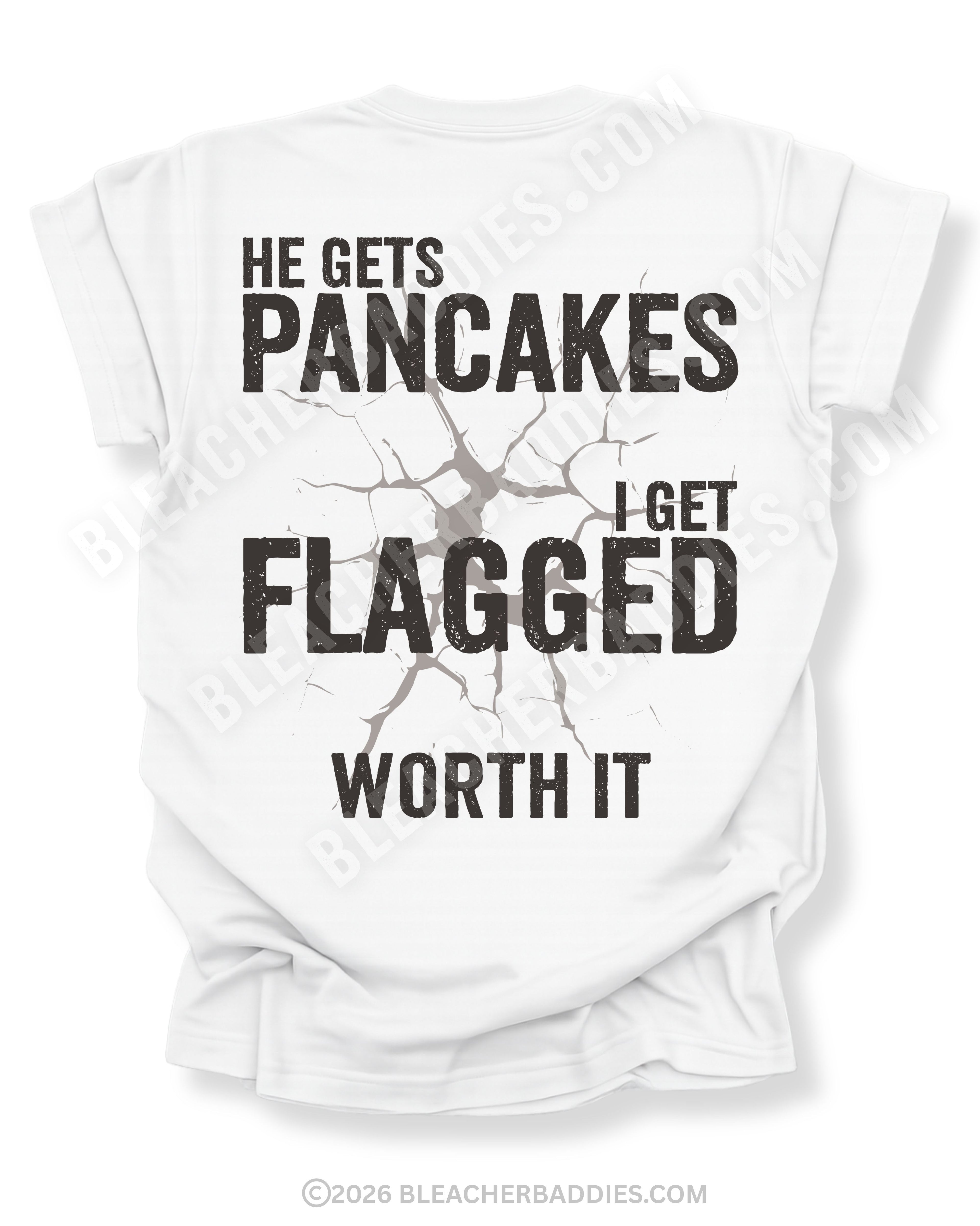 Football mom game day shirt with back design that reads “He gets pancakes I get flagged worth it” in distressed black text with a cracked impact graphic on a white tee