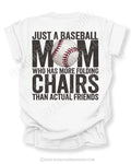 White Comfort Colors baseball mom game day shirt with distressed black text reading “Just a baseball mom who has more folding chairs than actual friends” and baseball graphic replacing the O in MOM