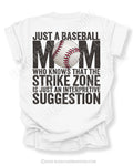 White Comfort Colors game day shirt with distressed back graphic reading “Just a Baseball Mom Who Knows That The Strike Zone Is Just An Interpretive Suggestion” with baseball graphic layered over MOM text