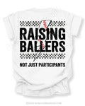 White Comfort Colors baseball mom shirt with distressed Raising Ballers graphic, checkerboard stripe details, red baseball seam design, and “Not Just Participants” wording on the back.