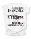 Back of white t-shirt with bold distressed text reading “He Dominates the Trenches I Dominate the Bleachers Same Team Different Players” with cracked graphic detail