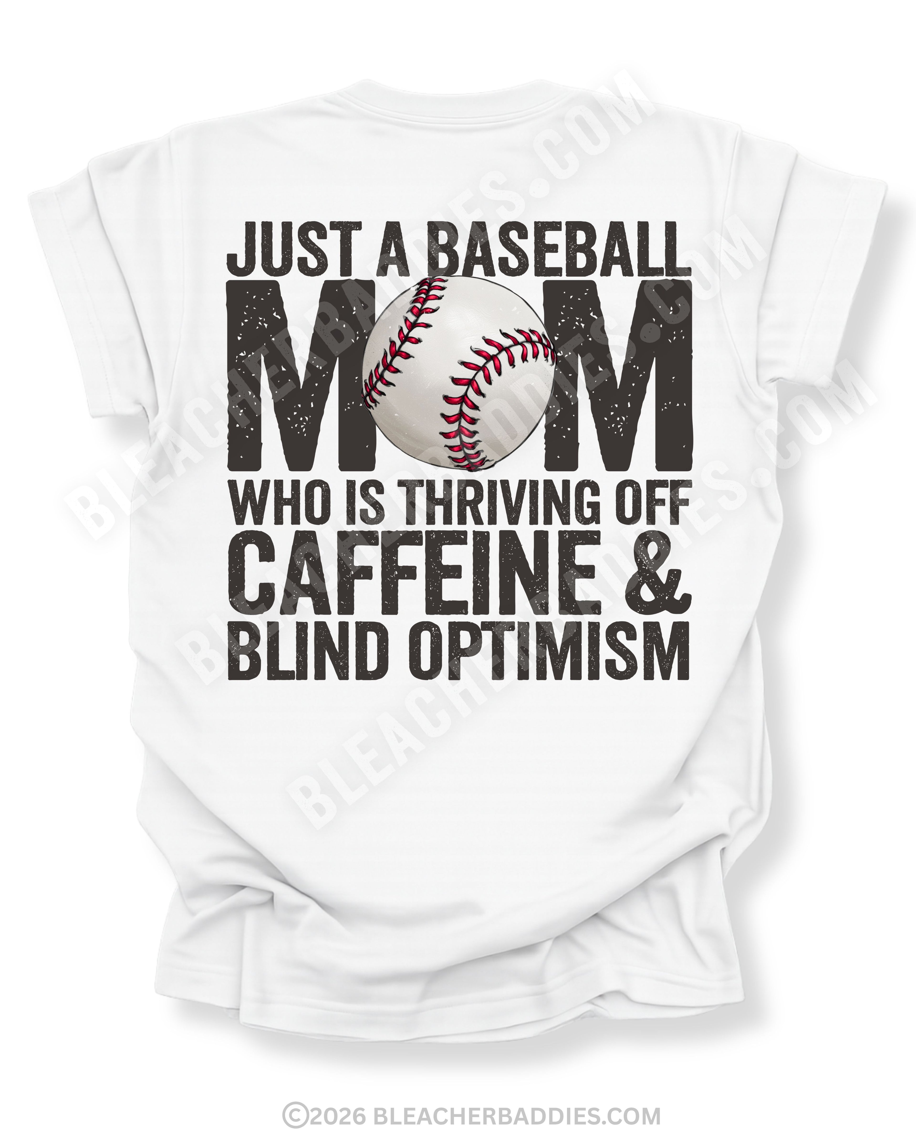 White baseball mom graphic tee featuring distressed black text reading “Just a baseball mom who is thriving off caffeine and blind optimism” with baseball graphic centered in the word MOM