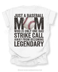 White baseball mom shirt with distressed oversized typography reading “Just a Baseball Mom Who Is Only One Bad Strike Call Away From Becoming Legendary” with baseball graphic layered over MOM text