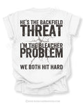 Back view of white Comfort Colors football mom game day shirt featuring “He’s the Backfield Threat I’m the Bleacher Problem We Both Hit Hard” bold graphic design