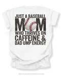White Comfort Colors game day shirt with distressed baseball mom back graphic reading “Just a Baseball Mom Who Thrives on Caffeine & Bad Ump Energy” with baseball graphic layered over MOM text