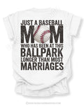 White Comfort Colors game day shirt with distressed back graphic reading “Just a Baseball Mom Who Has Been at This Ballpark Longer Than Most Marriages” with baseball graphic layered over MOM text