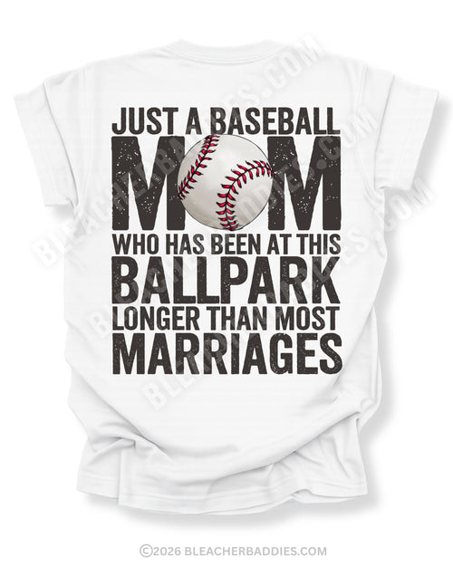 White Comfort Colors game day shirt with distressed back graphic reading “Just a Baseball Mom Who Has Been at This Ballpark Longer Than Most Marriages” with baseball graphic layered over MOM text