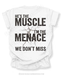 White Comfort Colors football mom game day shirt flat lay with back design that reads “He’s the muscle I’m the menace we don’t miss” in distressed black text with cracked impact graphic