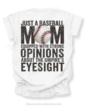 White Comfort Colors game day shirt with distressed back graphic reading “Just a Baseball Mom Equipped With Strong Opinions About The Umpire’s Eyesight” with baseball graphic layered over MOM text