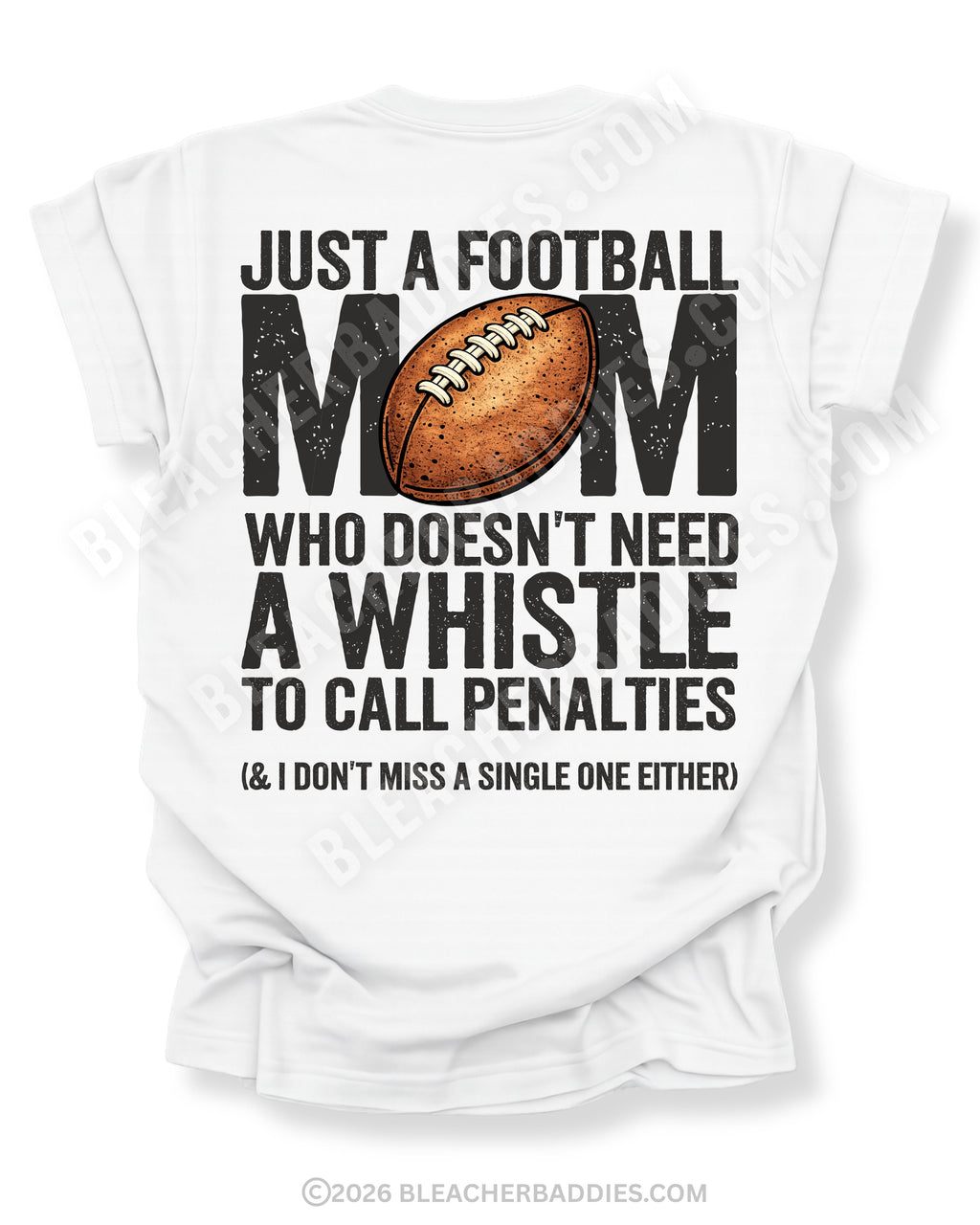 Football mom game day shirt flat lay on white Comfort Colors tee featuring bold back graphic that reads “Just a football mom who doesn’t need a whistle to call penalties and I don’t miss a single one either”