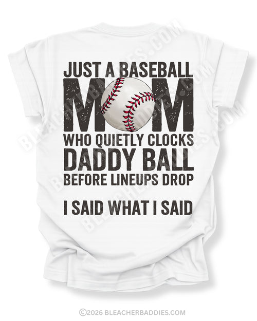 White Comfort Colors game day shirt with distressed back graphic reading “Just a Baseball Mom Who Quietly Clocks Daddy Ball Before Lineups Drop I Said What I Said” with baseball graphic layered over MOM text