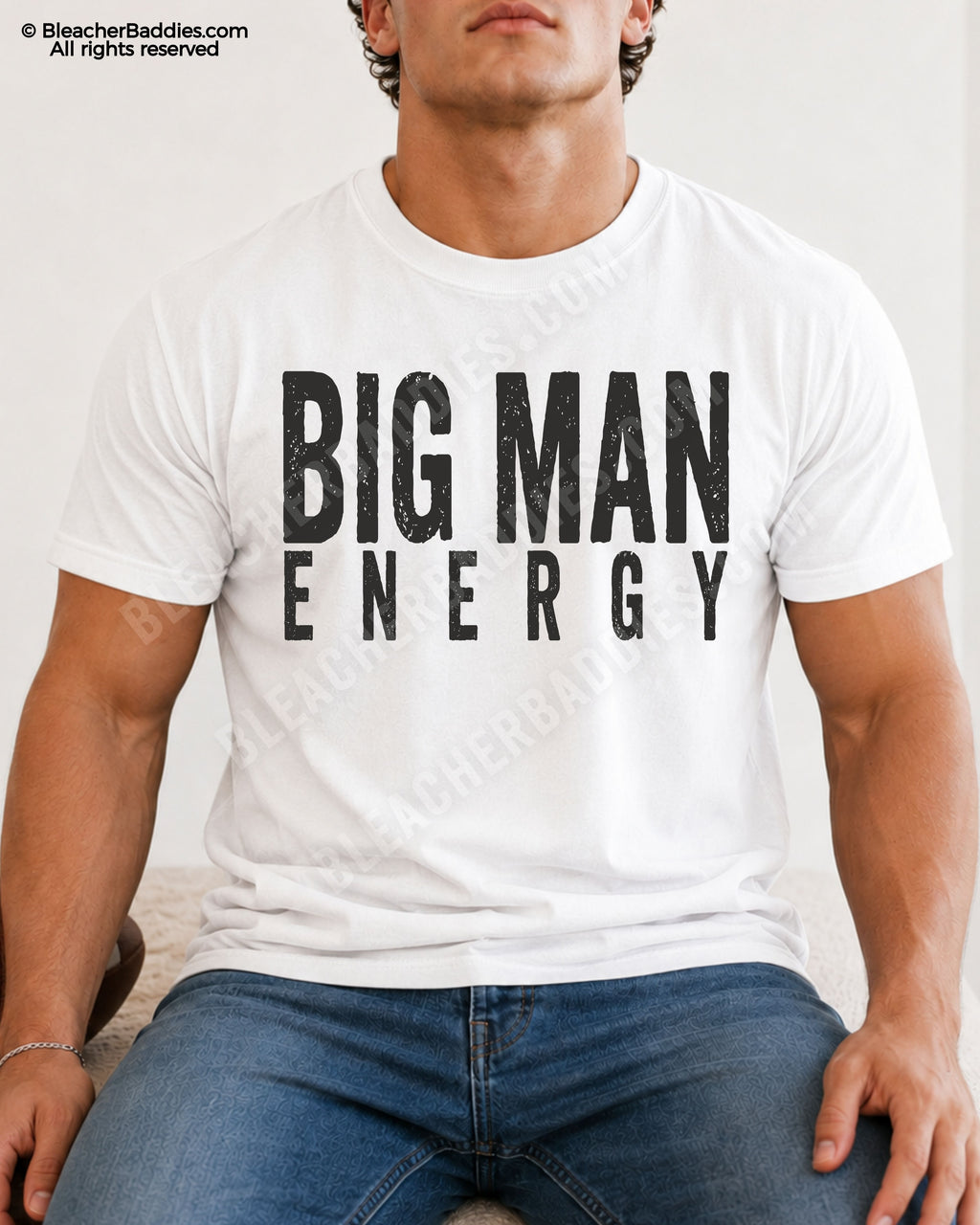 Male football player model wearing a white Comfort Colors Big Man Energy shirt with distressed black lettering while sitting indoors. Funny offensive line inspired game day shirt for linemen and big athletes.