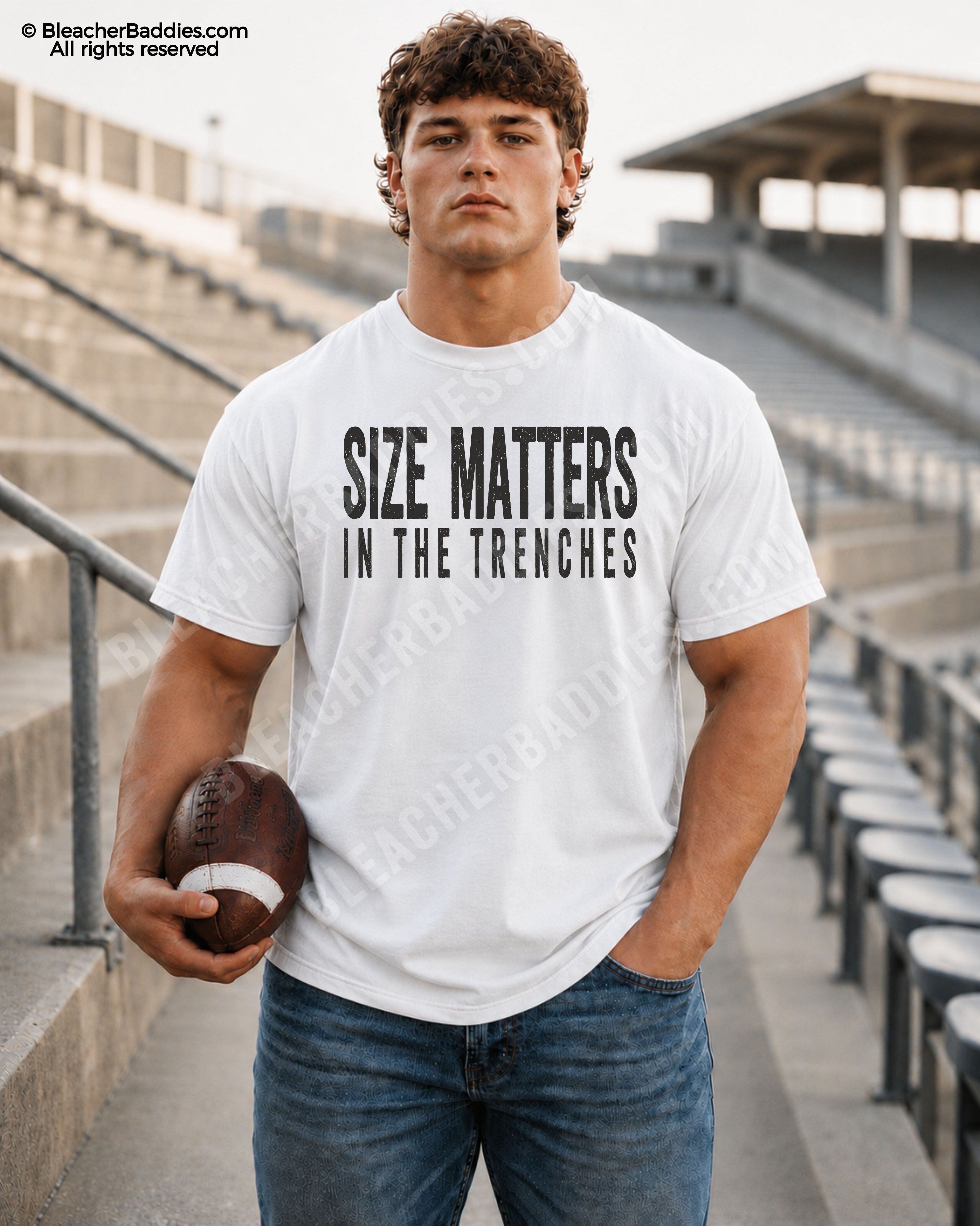 Football player standing in stadium bleachers wearing a white Comfort Colors offensive line game day shirt featuring distressed “Size Matters In The Trenches” text while holding a football.