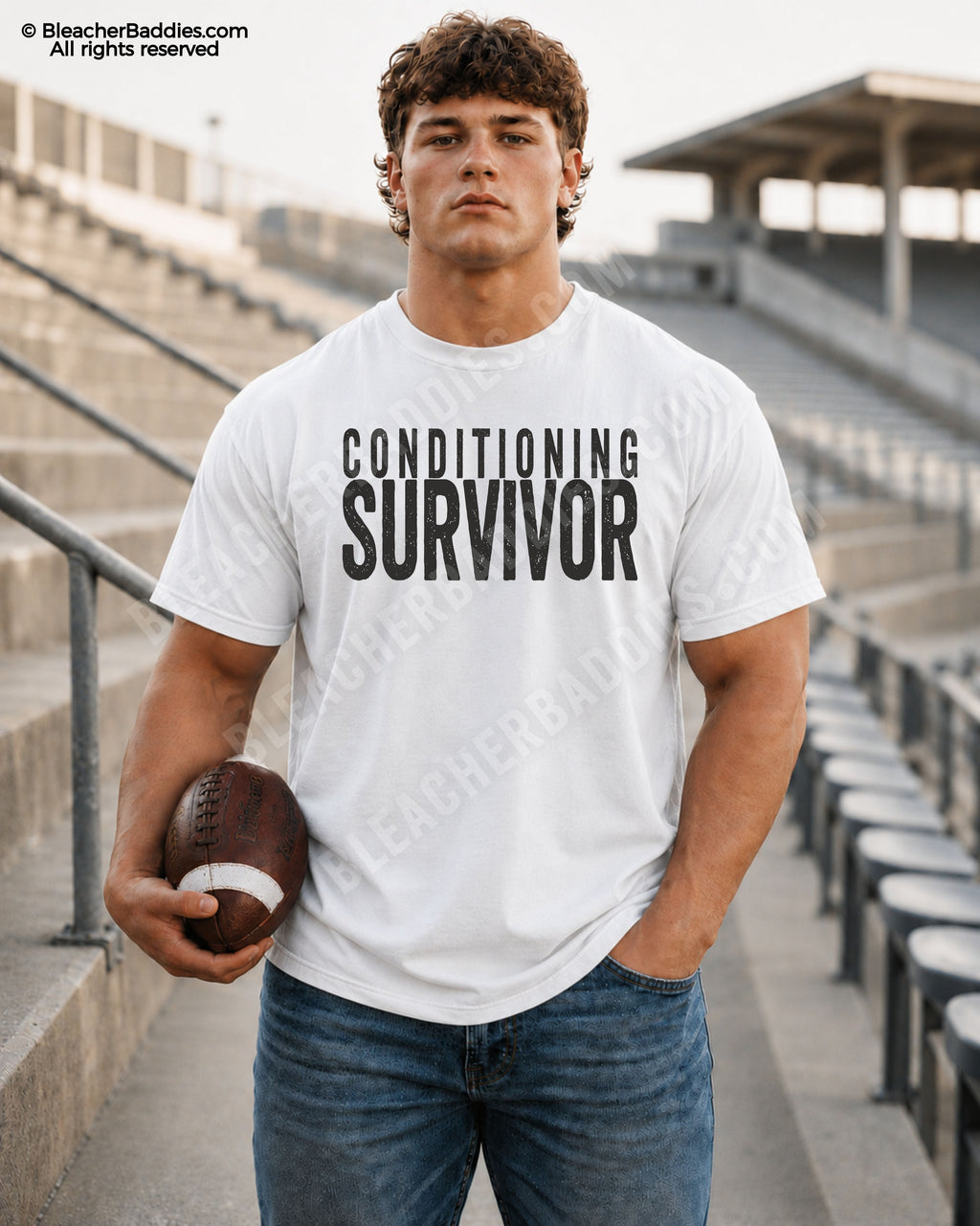 Football player standing in stadium wearing a white Comfort Colors “Conditioning Survivor” shirt with bold distressed lettering.