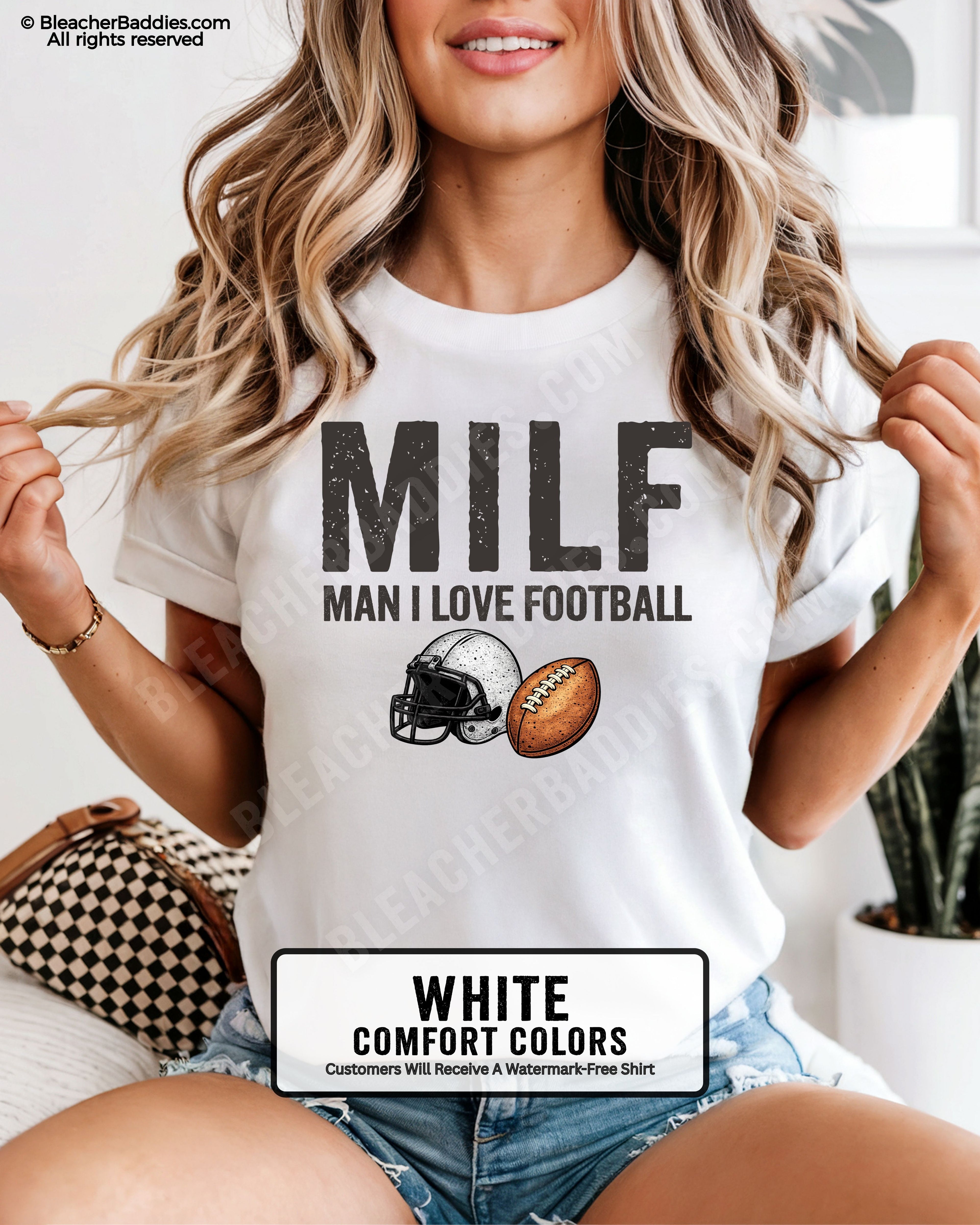 Woman wearing white comfort colors t-shirt that says “MILF Man I Love Football” with football helmet and ball graphic